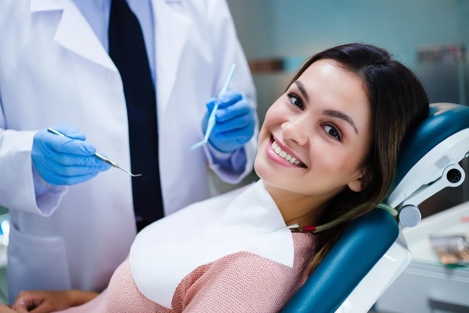 A smiling woman in the dental chair with her dentist